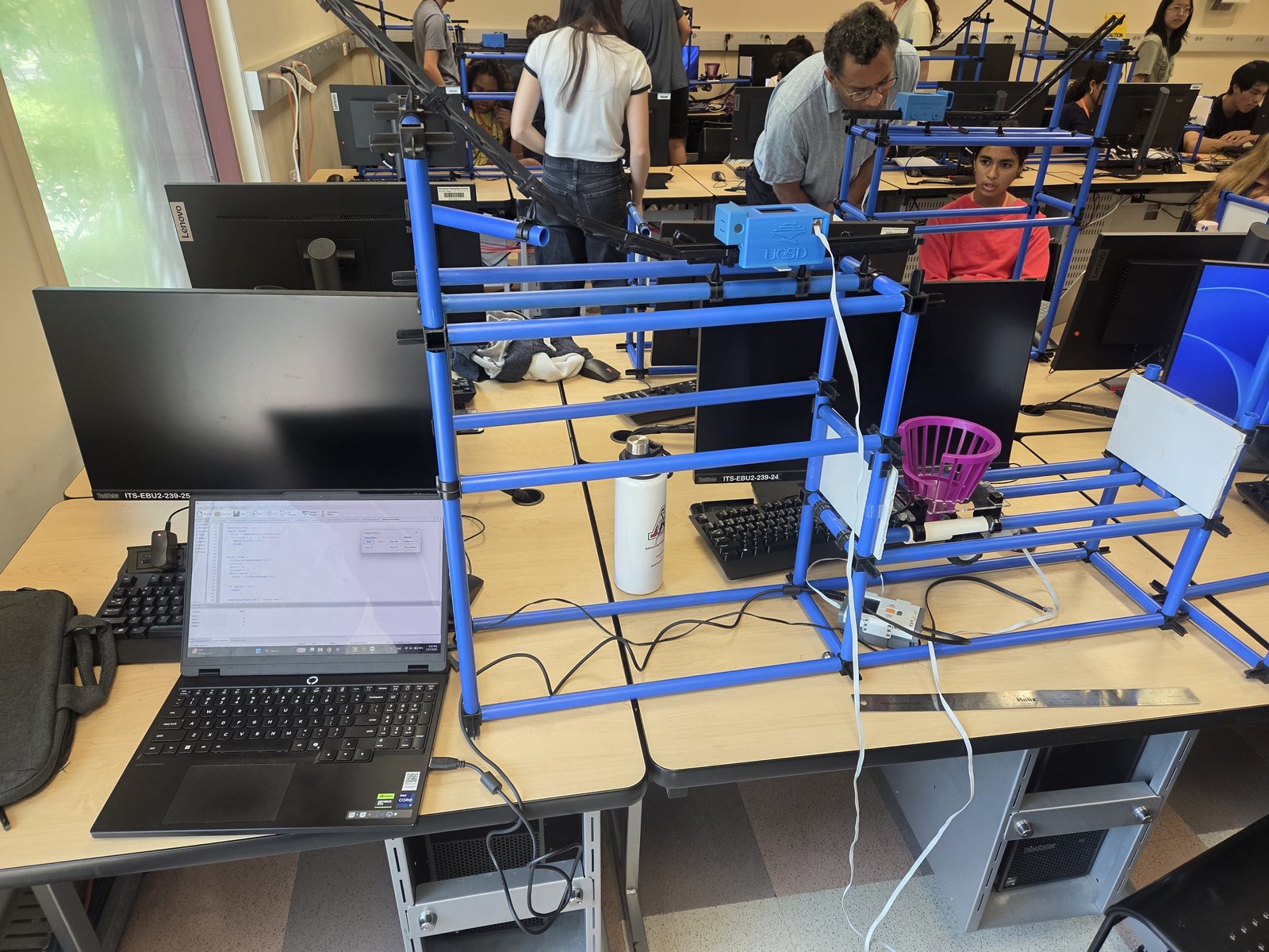J-CAR sculpture on a work table connected to a LEGO NXT controller